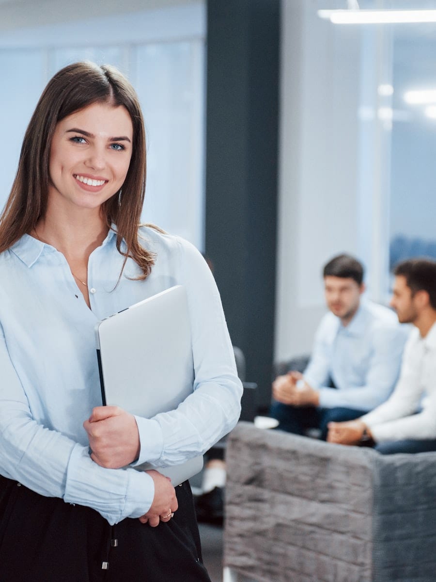 Smiling Boston businesswoman holding documents after loan approval